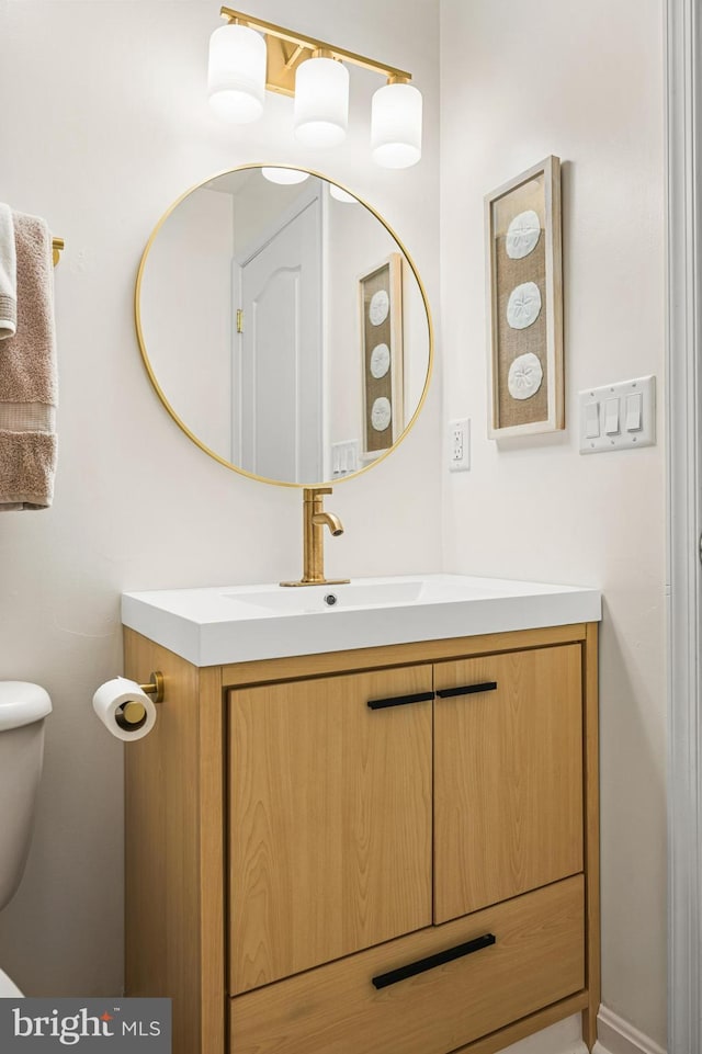 half bathroom with vanity and toilet