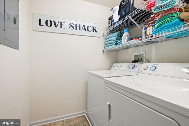 laundry room featuring electric panel, baseboards, independent washer and dryer, and laundry area