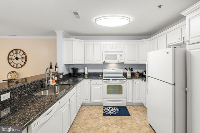 kitchen featuring a sink, visible vents, white appliances, and white cabinets