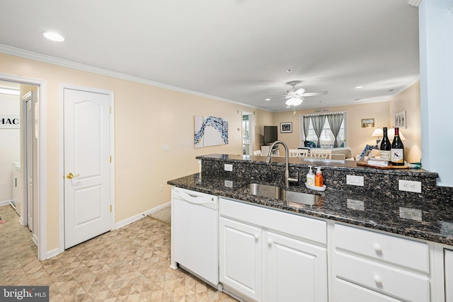 kitchen with a sink, white cabinets, white dishwasher, crown molding, and ceiling fan