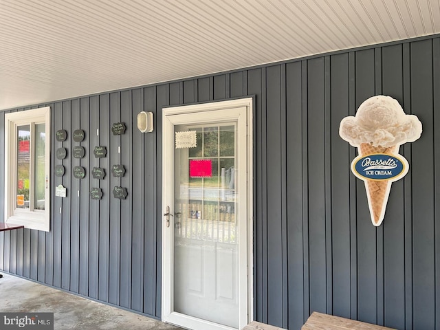 view of exterior entry featuring board and batten siding