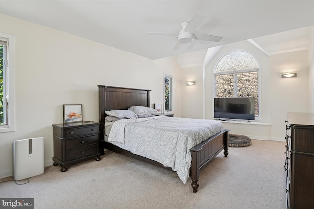 carpeted bedroom featuring baseboards, ceiling fan, and vaulted ceiling