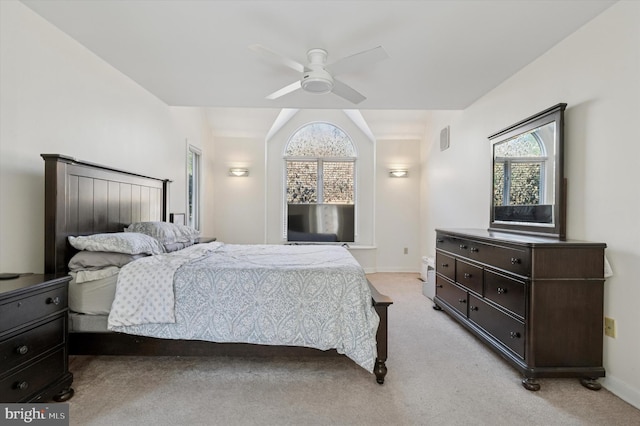 bedroom with light carpet, multiple windows, a ceiling fan, and baseboards