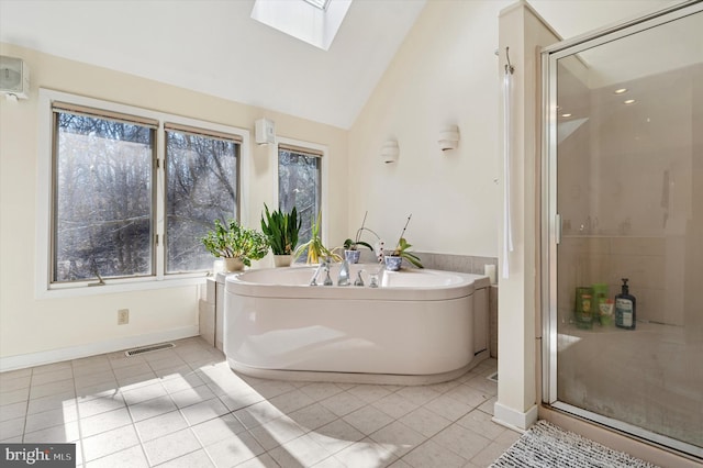 bathroom featuring tile patterned floors, visible vents, lofted ceiling with skylight, and a stall shower