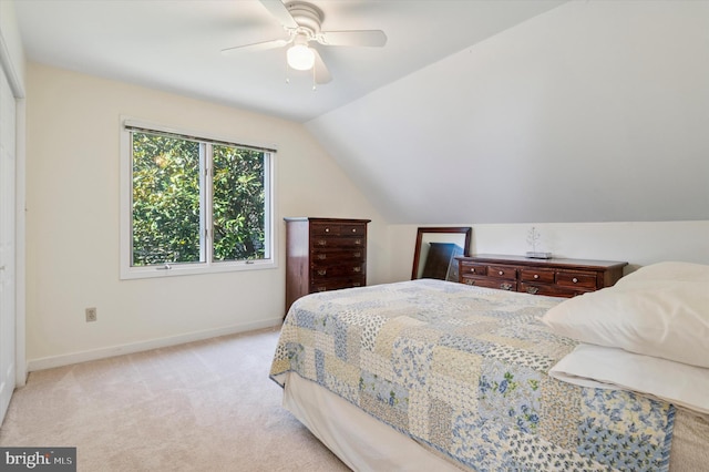 bedroom featuring baseboards, lofted ceiling, light colored carpet, and a ceiling fan