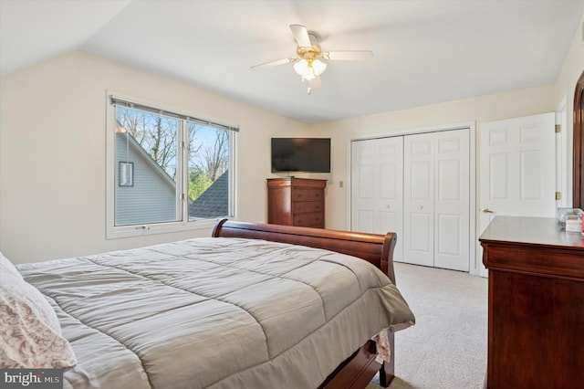 carpeted bedroom with a closet, a ceiling fan, and lofted ceiling