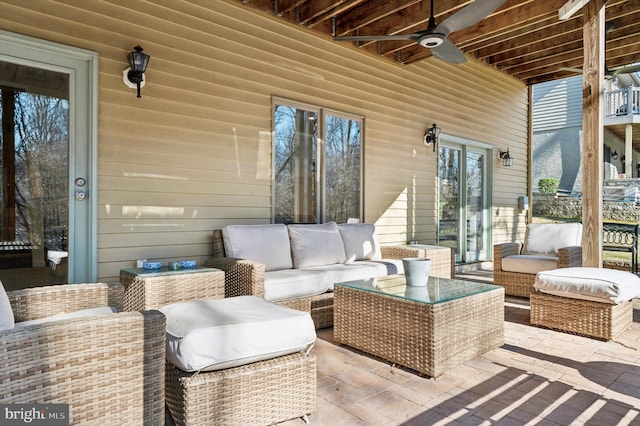 view of patio with an outdoor living space and ceiling fan