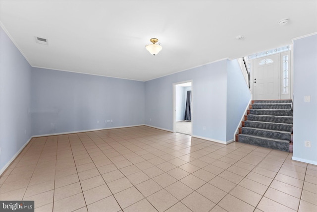 unfurnished living room featuring visible vents, baseboards, stairway, ornamental molding, and light tile patterned flooring