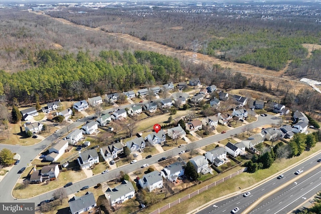 bird's eye view with a residential view and a wooded view