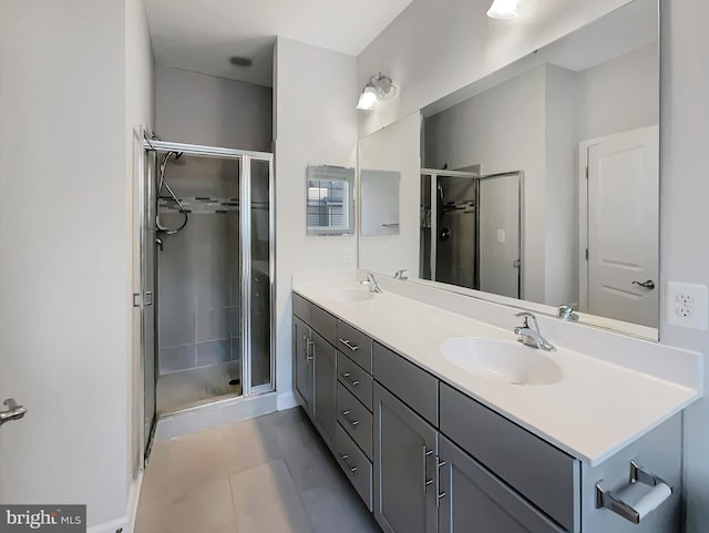 full bath with a sink, double vanity, and a shower stall