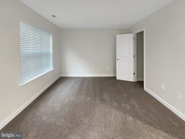 unfurnished room featuring baseboards