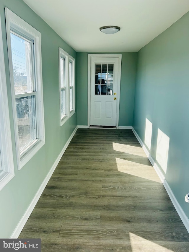 entryway with baseboards and wood finished floors