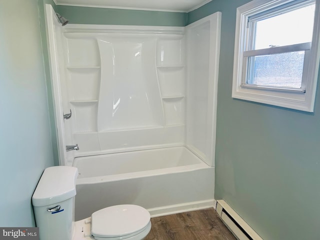 bathroom with baseboard heating, toilet, bathing tub / shower combination, and wood finished floors