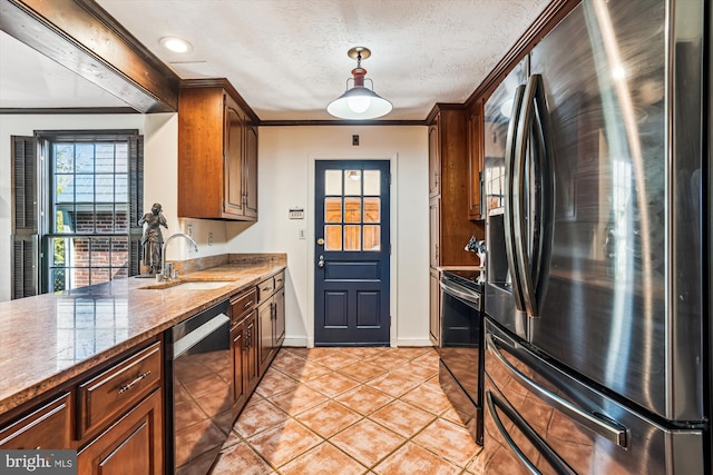 kitchen featuring ornamental molding, light tile patterned floors, appliances with stainless steel finishes, a textured ceiling, and a sink