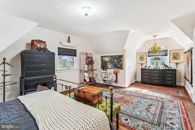 bedroom featuring hardwood / wood-style floors, vaulted ceiling, multiple windows, and baseboards