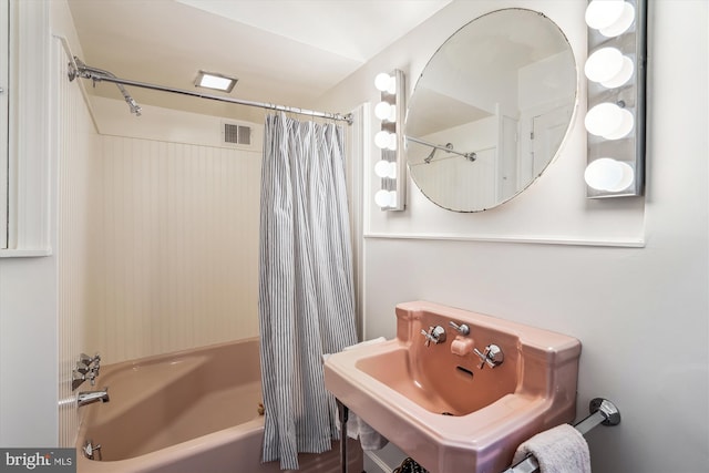 bathroom featuring a sink, visible vents, and shower / tub combo with curtain