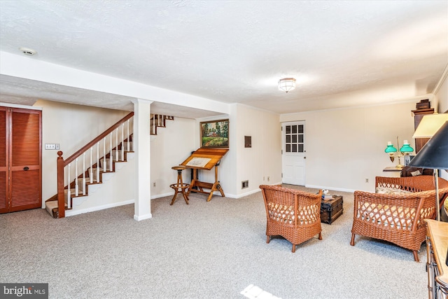 living room with visible vents, baseboards, carpet floors, stairs, and a textured ceiling