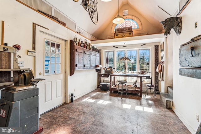 dining space featuring plenty of natural light, baseboards, and high vaulted ceiling