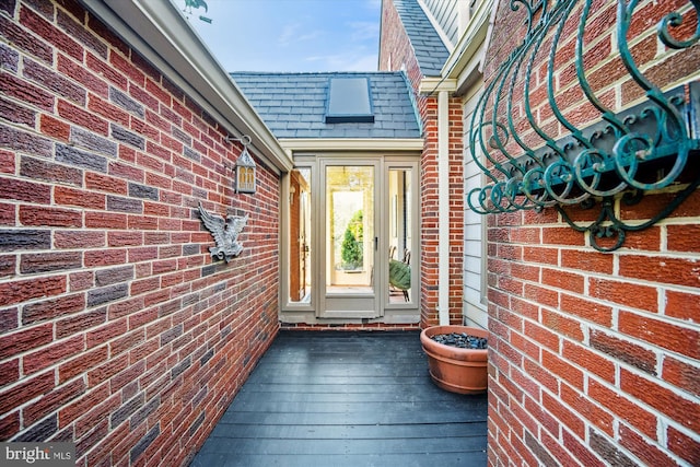 view of exterior entry featuring brick siding