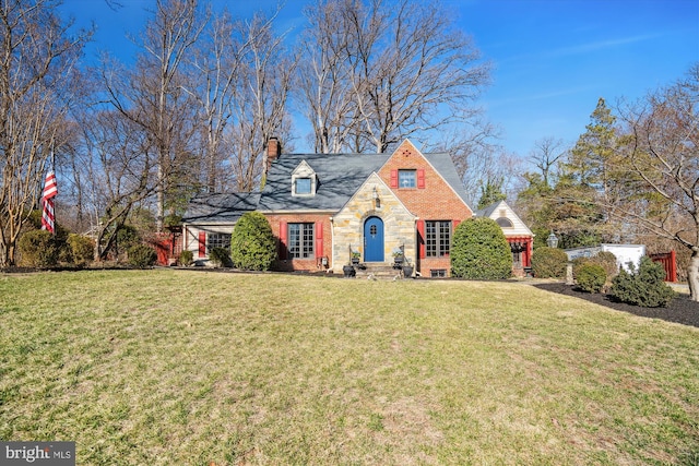 view of front of house with stone siding, a chimney, and a front lawn