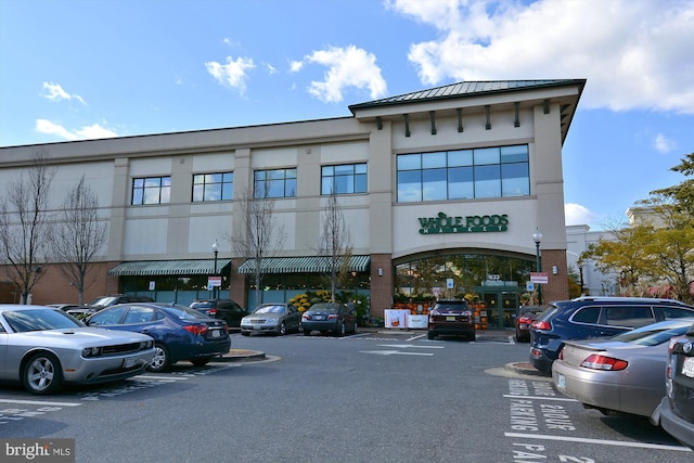 view of building exterior with uncovered parking