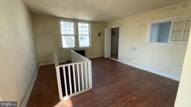 empty room featuring baseboards and wood finished floors