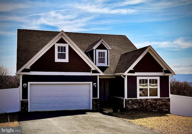 view of front of house with fence, a garage, and driveway