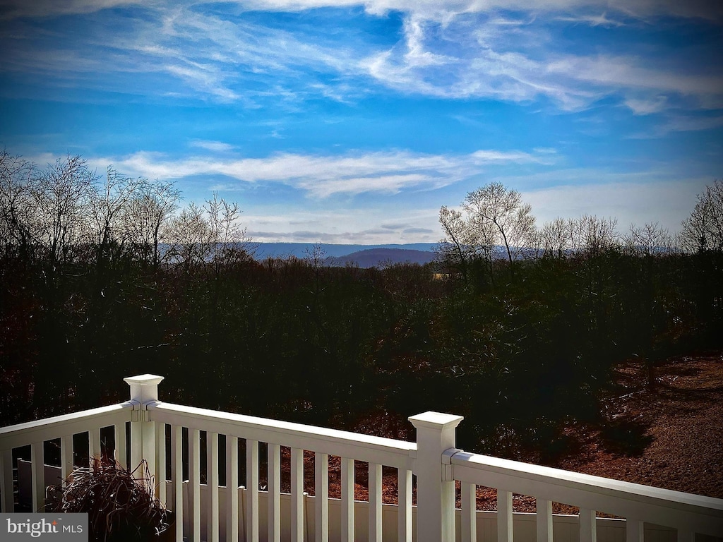 view of yard featuring a mountain view and a balcony