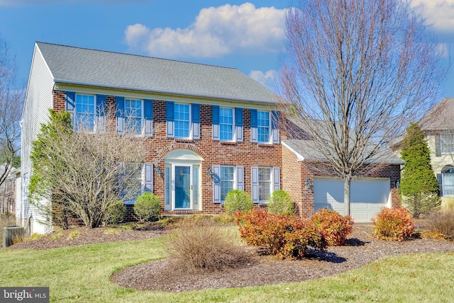 colonial inspired home featuring central air condition unit, a garage, brick siding, and roof with shingles