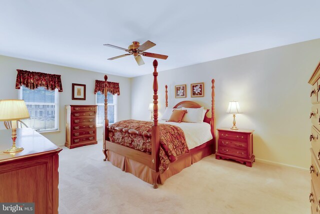 carpeted bedroom with baseboards and ceiling fan