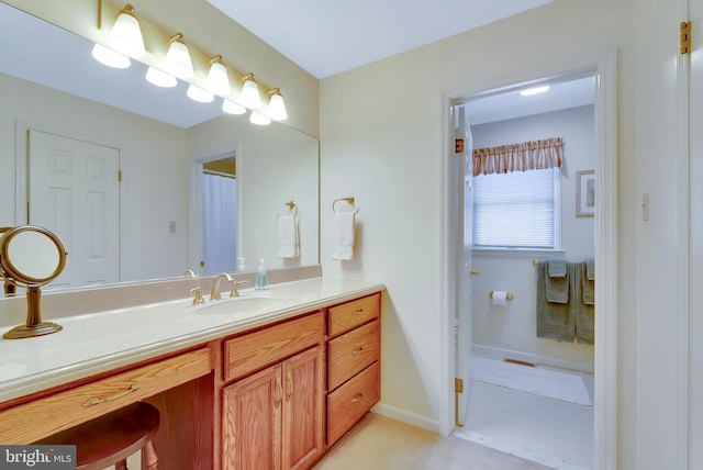 bathroom with baseboards and vanity