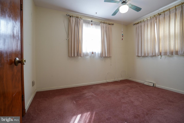 unfurnished room featuring carpet flooring, a ceiling fan, and baseboards