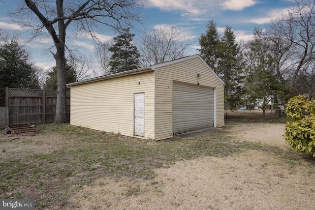 detached garage featuring fence