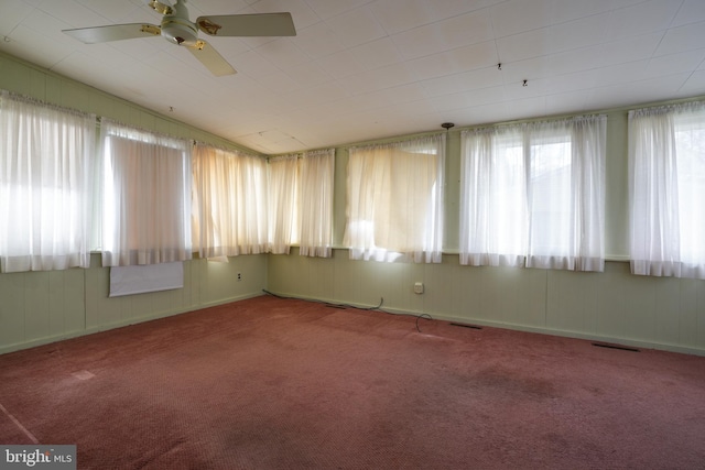 spare room featuring visible vents, carpet floors, and ceiling fan