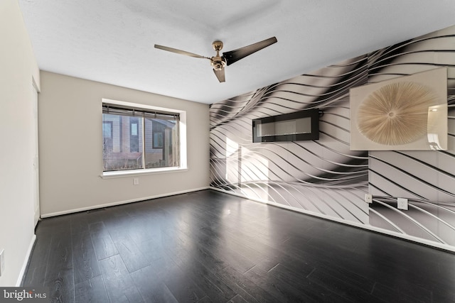 interior space featuring baseboards, wood finished floors, and a ceiling fan