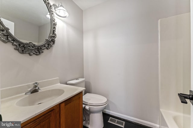 bathroom with vanity, toilet, and visible vents