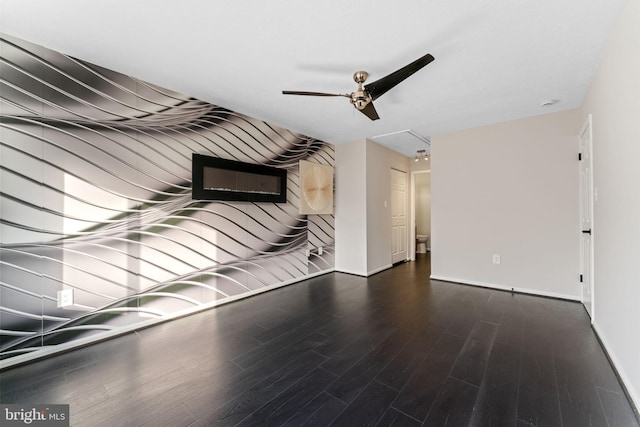 unfurnished living room featuring baseboards, ceiling fan, and wood finished floors