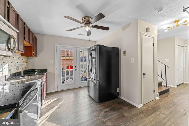 kitchen featuring stainless steel appliances, visible vents, dark wood finished floors, and french doors