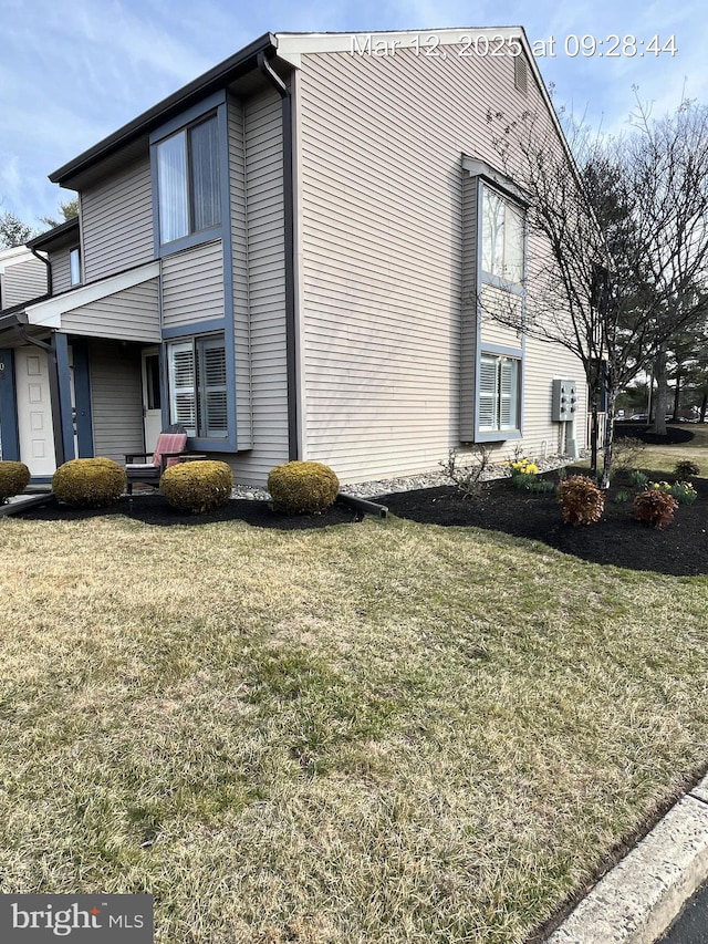 view of home's exterior with a lawn