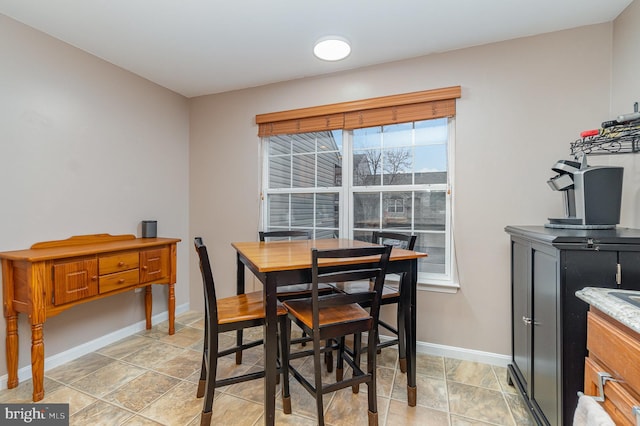 dining area featuring baseboards