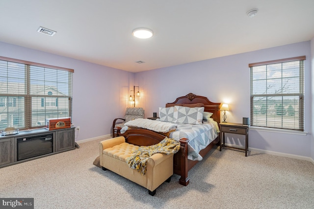 carpeted bedroom featuring visible vents and baseboards