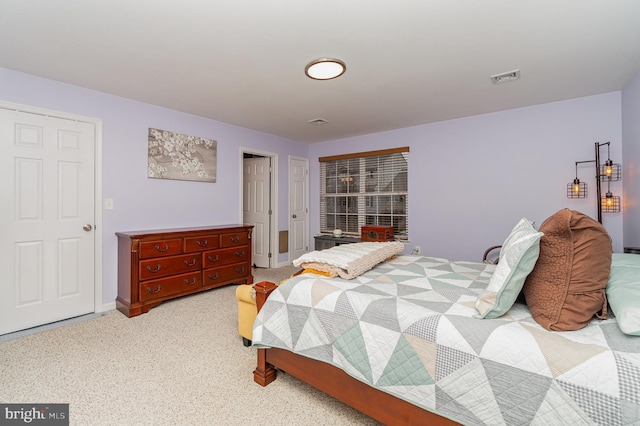 bedroom featuring visible vents, baseboards, and carpet flooring