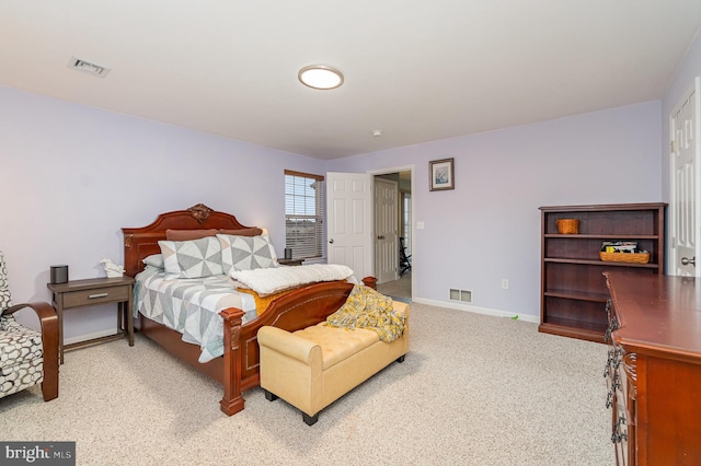 carpeted bedroom with baseboards and visible vents