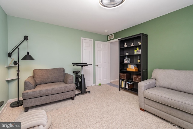 living area with visible vents, carpet floors, and baseboards