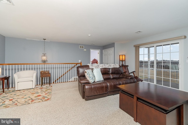 living room with visible vents and light carpet