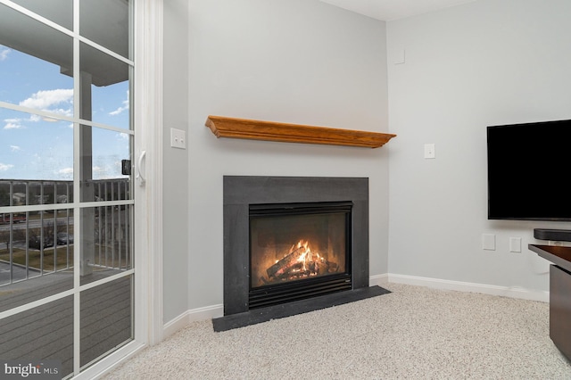 room details with baseboards, a fireplace with flush hearth, and carpet floors