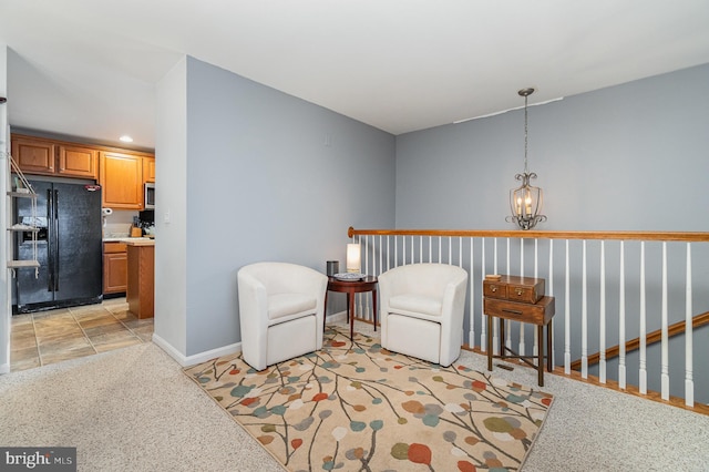 sitting room with recessed lighting, baseboards, and an inviting chandelier