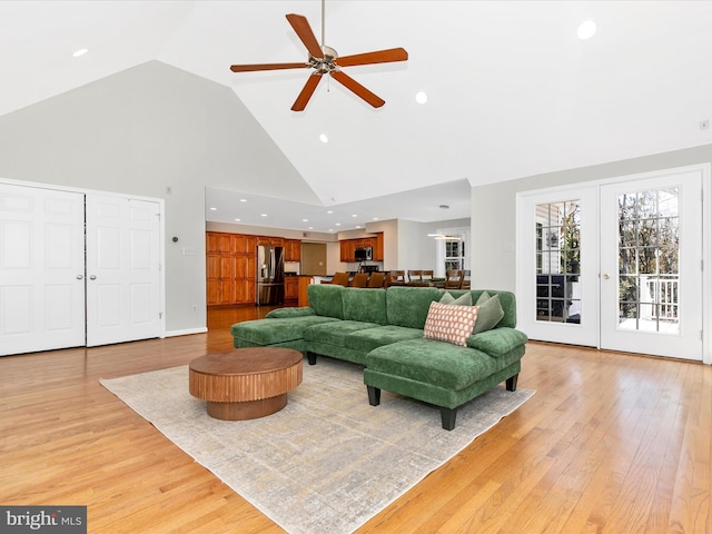 living room featuring light wood-type flooring, high vaulted ceiling, a ceiling fan, recessed lighting, and baseboards