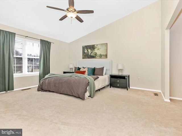 carpeted bedroom featuring a ceiling fan, visible vents, baseboards, and high vaulted ceiling