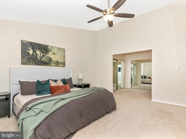 carpeted bedroom with ceiling fan and baseboards